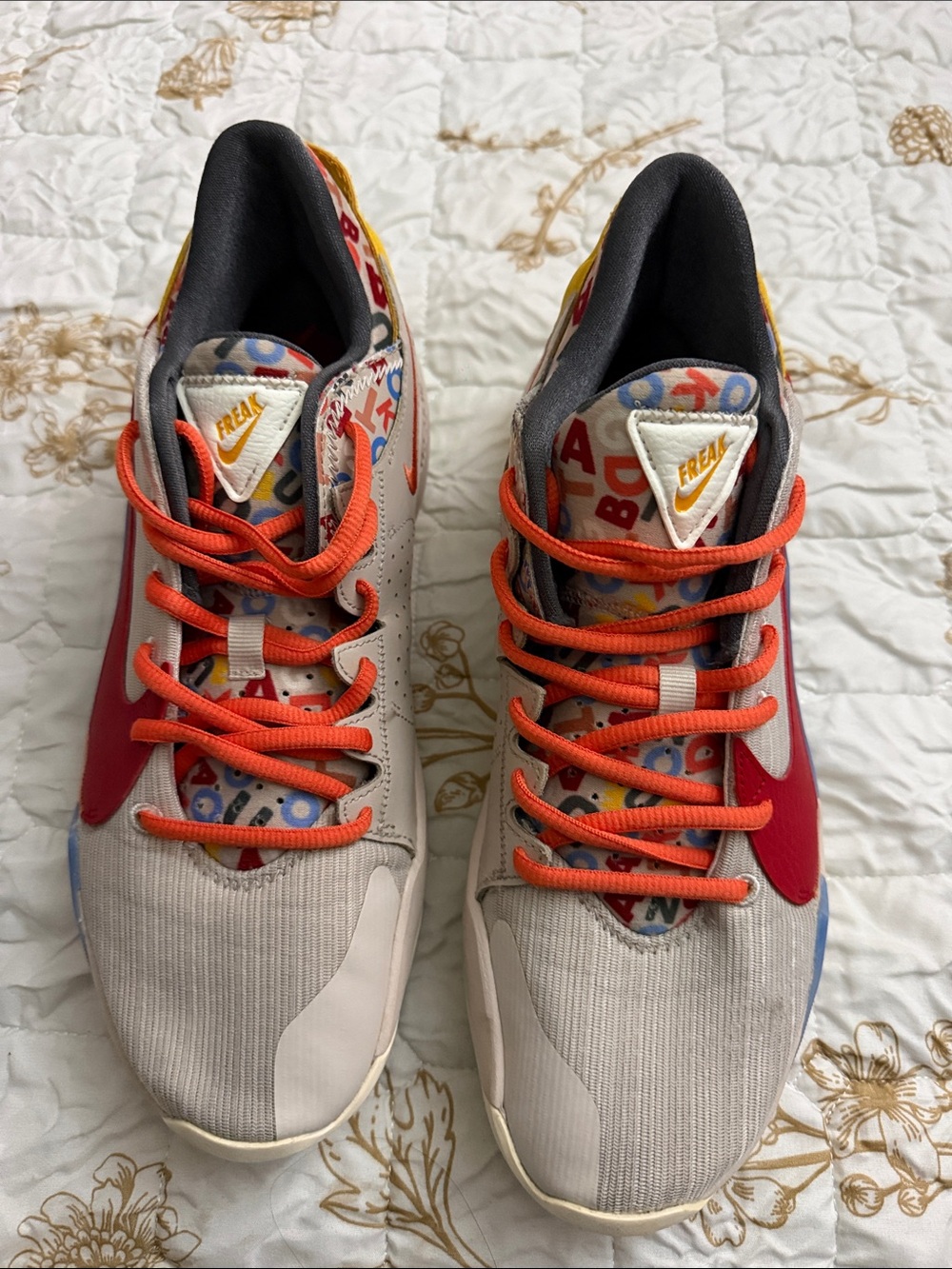Nike Kids Beige Sneakers with Orange Laces and Red Swoosh